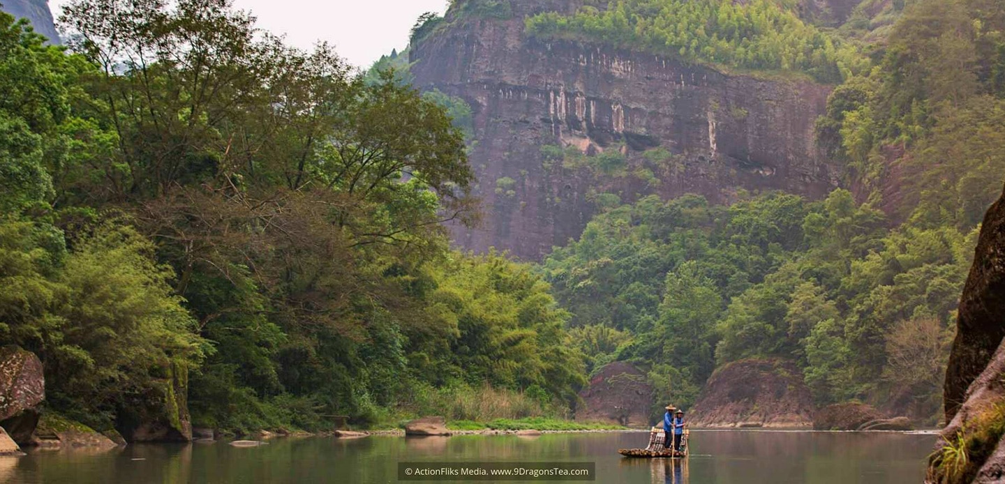 wuyishan landscape river rafters on bamboo raft with mountain