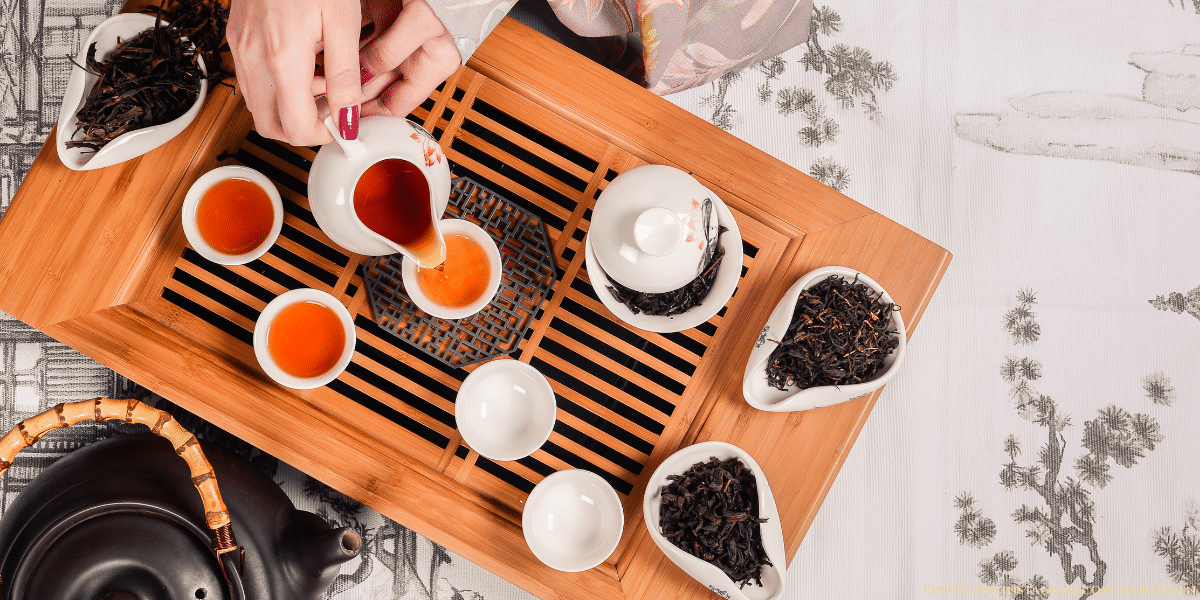Drinking Black tea Chinese style with traditional tea accessories 