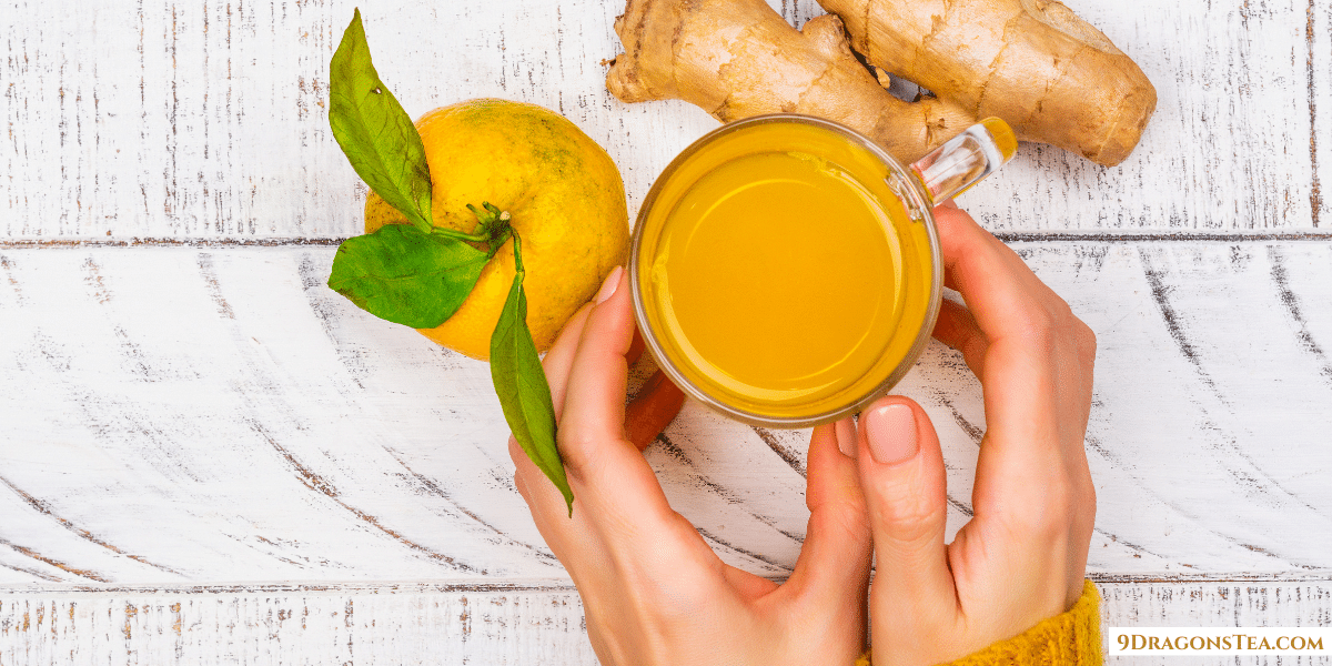 Ginger Tea Health Benefits-a cup of Ginger tea with lemon held in hand